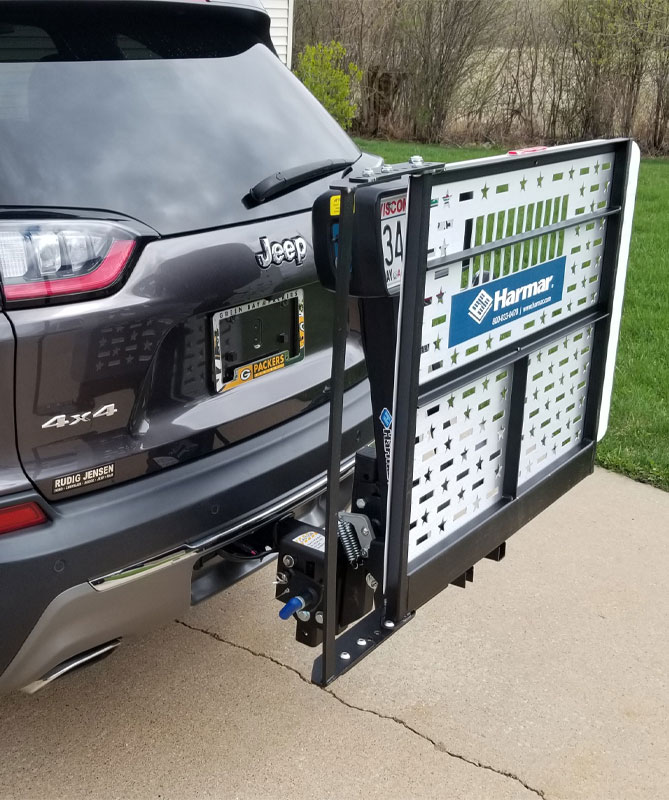 A hitch lift attaches to the vehicle by
            means of a hitch and receiver and consists of an actuator and platform which
            secures and carries a manual chair, scooter, or powerchair.